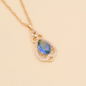 Elegant gold necklace with a teardrop gradient blue-green gemstone and white diamonds