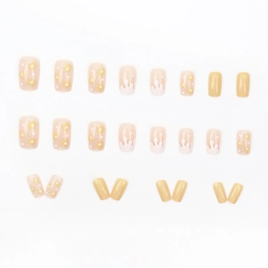 Square nude pink and yellow daisy press-on nails set with glossy floral and fluid designs