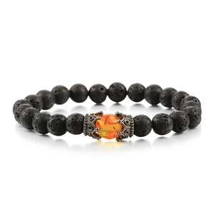 Detail of black lava stone beads with orange amber-style centerpiece on woven bracelet