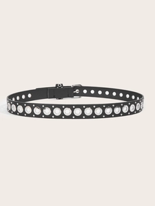 Detail of black punk leather belt featuring double silver eyelets and metal stud trim