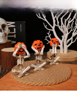 Three-piece pumpkin head skeleton figurines in see hear speak no evil yoga poses