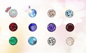 Macro display of 12 varieties of round cut gemstones like Opal and Emerald on pink floral