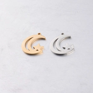Detailed view of hollow moon and star charms in gold and silver mirror polished steel