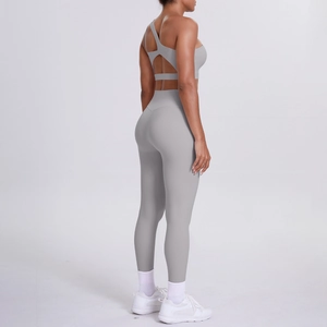 Detail of grey cross-back yoga bra and high-waisted leggings set for fitness