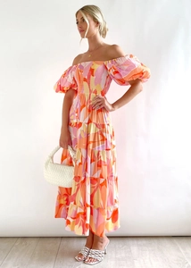 Detail of smocked bodice and puff sleeves on a floral off-shoulder maxi dress