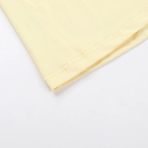 Vue détaillée de l'ourlet de robe jaune clair avec couture professionnelle à double aiguille