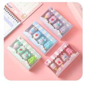 Flat lay of colorful ice cream and rabbit shaped erasers in pastel gift boxes