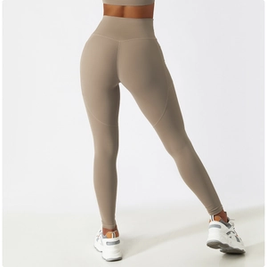 Detail of high-waisted yoga leggings showing side pocket and butt-lifting seam in khaki