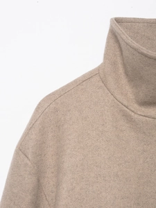 Close-up of camel wool bomber jacket collar and shoulder with high-quality knit texture
