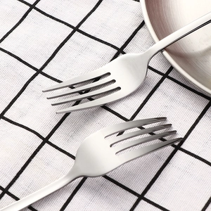 Outdoor camping stainless steel fork set on plaid cloth with portable picnic plate