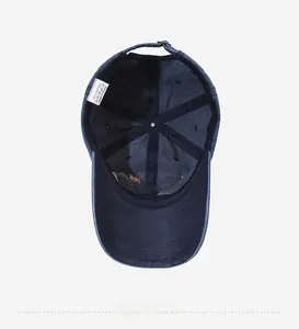 Detail showing the inner structure of a navy cotton baseball cap with wash label