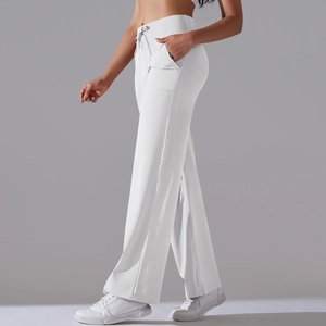 Detail of white high-waisted wide-leg yoga pants featuring drawstring and side pockets