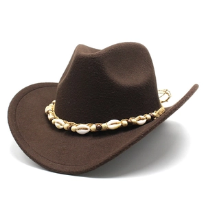 Detail view of ethnic weave band with seashells and wooden beads on a brown felt cowboy hat