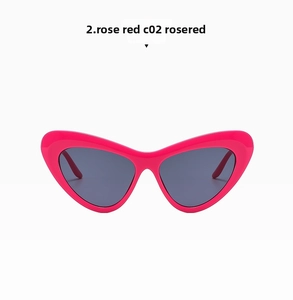 Detail of rose red cat-eye sunglasses with dark UV400 lenses and glossy resin frame