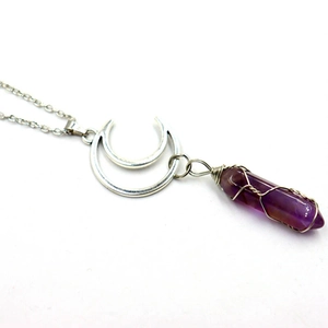 Silver double moon necklace with purple amethyst hexagonal crystal pendant on white background
