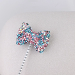 Sparkling pink and blue bow pendant with colorful rhinestones on silver metal stem