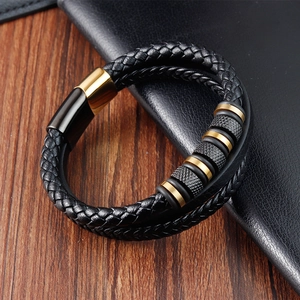 Multi-layer black braided leather bracelet with gold metal accents and magnetic clasp