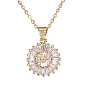 Gold plated copper necklace with zircon paved letter M pendant on white background