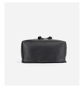 Detail shot of the black textured leather drawstring pouch with elegant knot accents