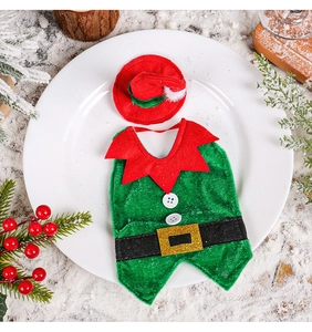 Detailed view of Christmas elf bottle cover with green vest and red hat on a holiday table