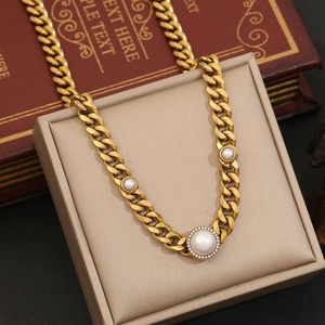 Gold Cuban link chain necklace featuring a large pearl with a rhinestone halo design