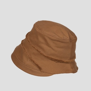 Detail of caramel cotton bucket hat with distressed raw edges and vintage trim work