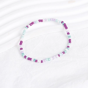 Detailed macro view of colorful bohemian beaded bracelets set on clean white background