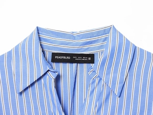 Detail of blue and white striped shirt collar showing high-quality stitching and label