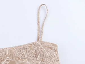 Close-up of white leaf embroidery and fine strap on khaki cotton linen wide leg set
