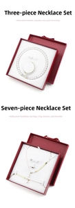 Detail of red jewelry gift boxes with bow tie including pearl necklaces and bracelets