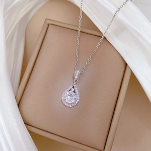 Macro shot of silver teardrop pendant necklace with sparkling micro-pave crystals