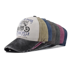 Close-up of assorted vintage washed cotton baseball caps with motorcycle print embroidery