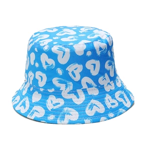 Detailed pattern of blue bucket hat with white heart graffiti and polka dots print