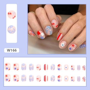 Detailed view of colorful summer press-on nails set with star and floral patterns