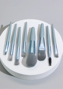 8-piece mini makeup brush set with wooden handles, soft bristles for powder, eyeshadow, and highlighting.