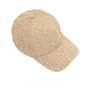 Detailed top view of beige baseball cap featuring textured seersucker pleated fabric