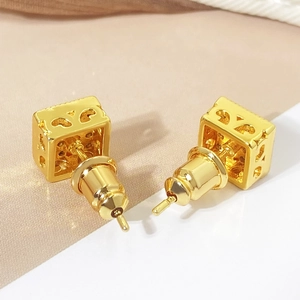 Golden cube stud earrings with intricate hollow patterns and micro-set cubic zirconia
