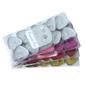 Glittery heart-shaped tea light candles in gold, silver and rose red for romantic decor