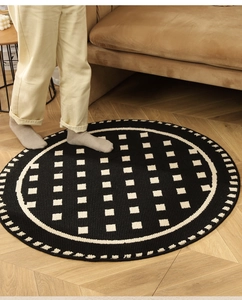 Detailed texture of black and white checkered round rug with soft woven material surface