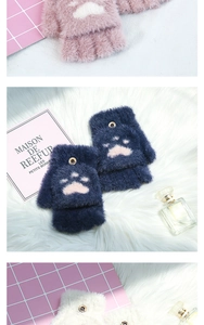 Detail of plush cat paw fingerless gloves with flip covers in pink, blue, and white
