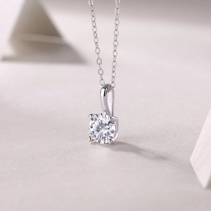 Macro shot of silver S925 necklace showing four-prong setting and round-cut diamond detail