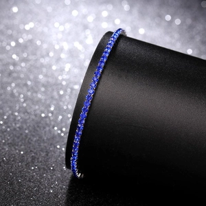 Close-up of a 2.0mm elastic bracelet featuring sparkling round blue crystals on a black base