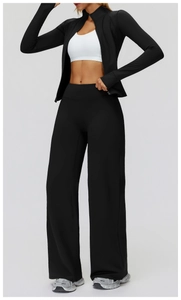 Detail of high-waisted black wide-leg sports pants and matching zip-up jacket set