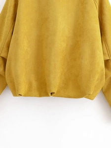 Macro shot of the elastic hem detail on a mustard yellow faux suede casual jacket