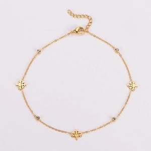 Detail of gold tree anklet with sparkling round rhinestones and adjustable lobster clasp