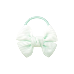Detail view of a mint green ribbed grosgrain bow hair tie with elastic band for styling