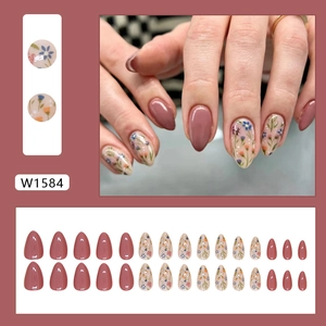 Short almond press-on nails with dusty rose polish and delicate floral patterns