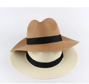 Detail of straw Panama hats in light brown and beige with classic black decorative bands