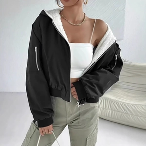 Detail of black fleece jacket showing white sherpa lining and sleeve zipper pocket