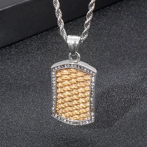 Macro detail of punk dog tag pendant with gold scale texture and sparkling crystals